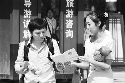 9月13日，西安臨潼華清池景區(qū)服務(wù)人員向游客介紹《旅游法》。