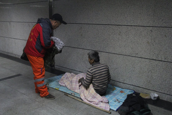在鄭州一處地下通道，孫德坤挑了幾件衣服送給了流浪者