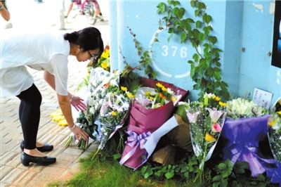 6月8日下午，記者來到廈門公交車爆炸事發(fā)現(xiàn)場橋下，附近已聚集了十幾個(gè)自發(fā)前來悼念的市民。橋墩下排放了一圈或黃或白的菊花，還有玖瑰、百合等。
