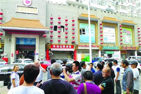 青島宰客海鮮店成“景點”，游人“參觀”拍照。