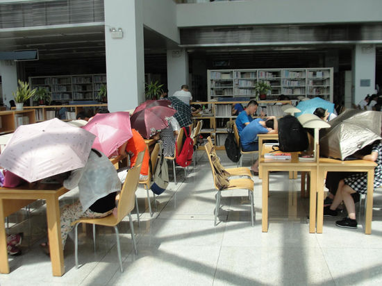 圖書館內(nèi)撐傘讀書的民眾。